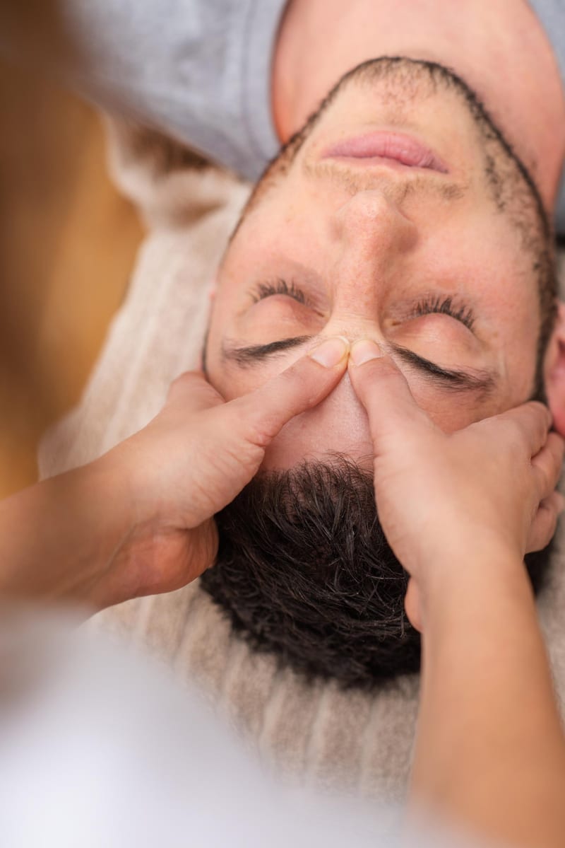 A person receiving a facial massage