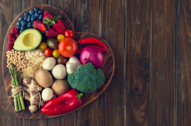 Fruit, vegetables and nuts arranged in a heart shape