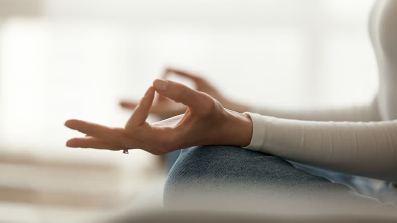 A hand resting in a meditation pose