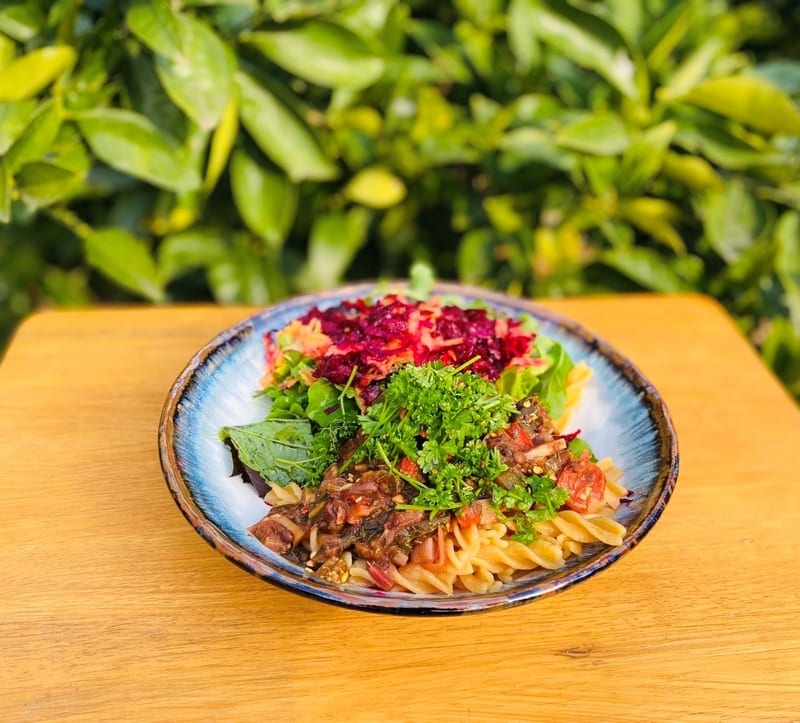 A bowl of lentil bolognese with herbs