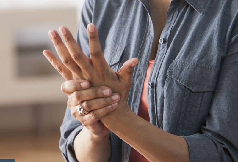 A person holding their wrist