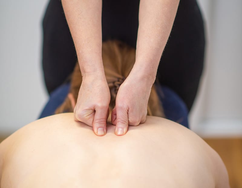 Hands applying a back massage