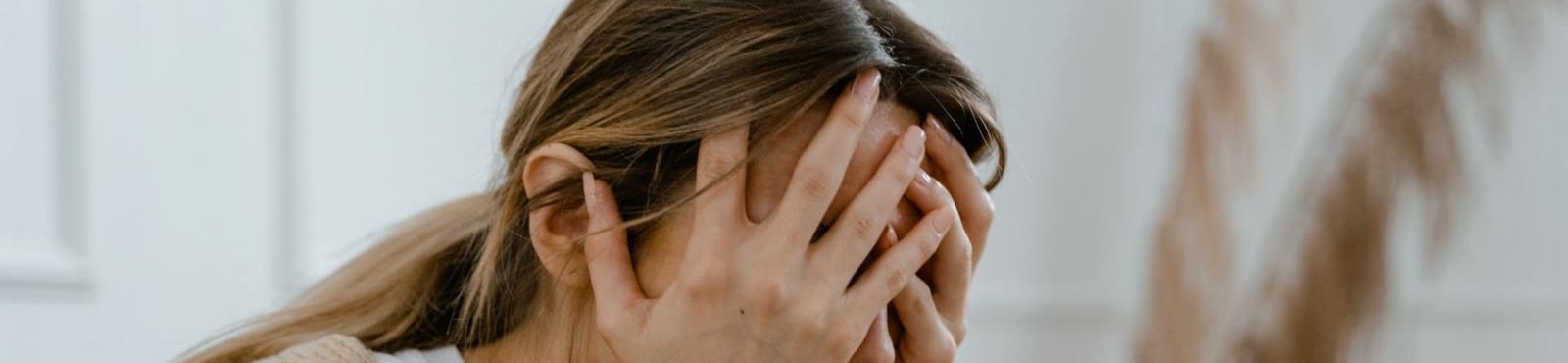 A woman resting her face in her hands